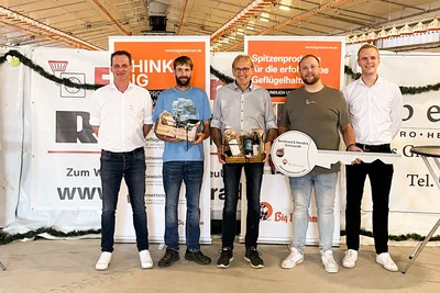 Una llave XXL para una cita importante: Para la inauguración de la nave, los empleados de Big Dutchman Werner Meckelnborg y Tobias Ideler entregan la llave simbólica de la nave a la familia Zumsande (de la izquierda a la derecha: Werner Meckelnborg, Jan Zumsande, Bernhard Zumsande, Hendrik Zumsande, Tobias Ideler). 